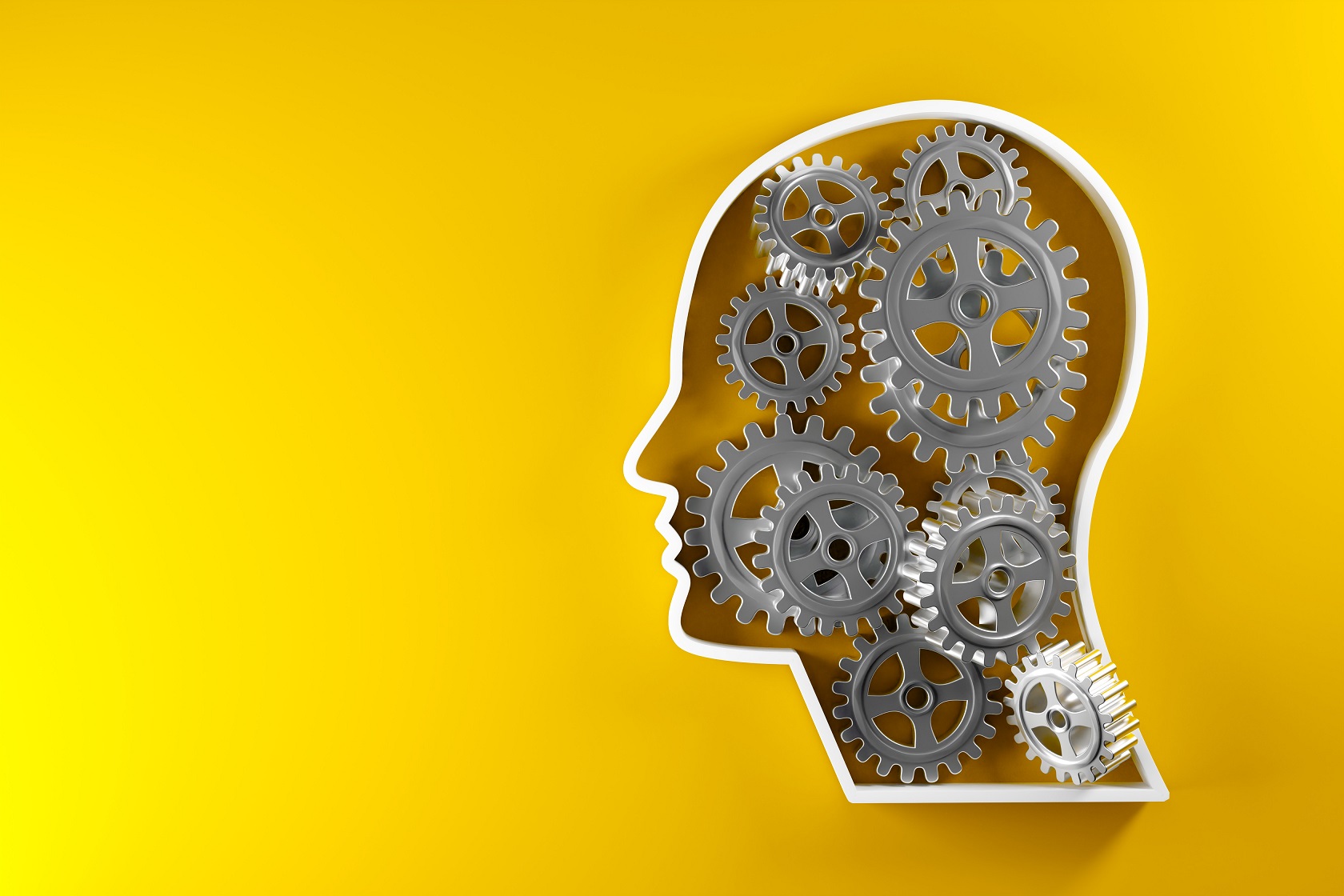 Outline of a human head with cogwheels on a yellow background